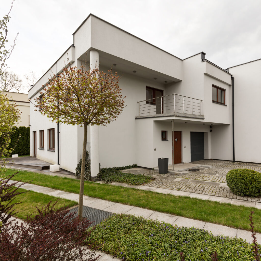 White mansion in new style with garden, exterior view